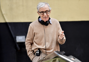 Woody Allen smiling on a film set.