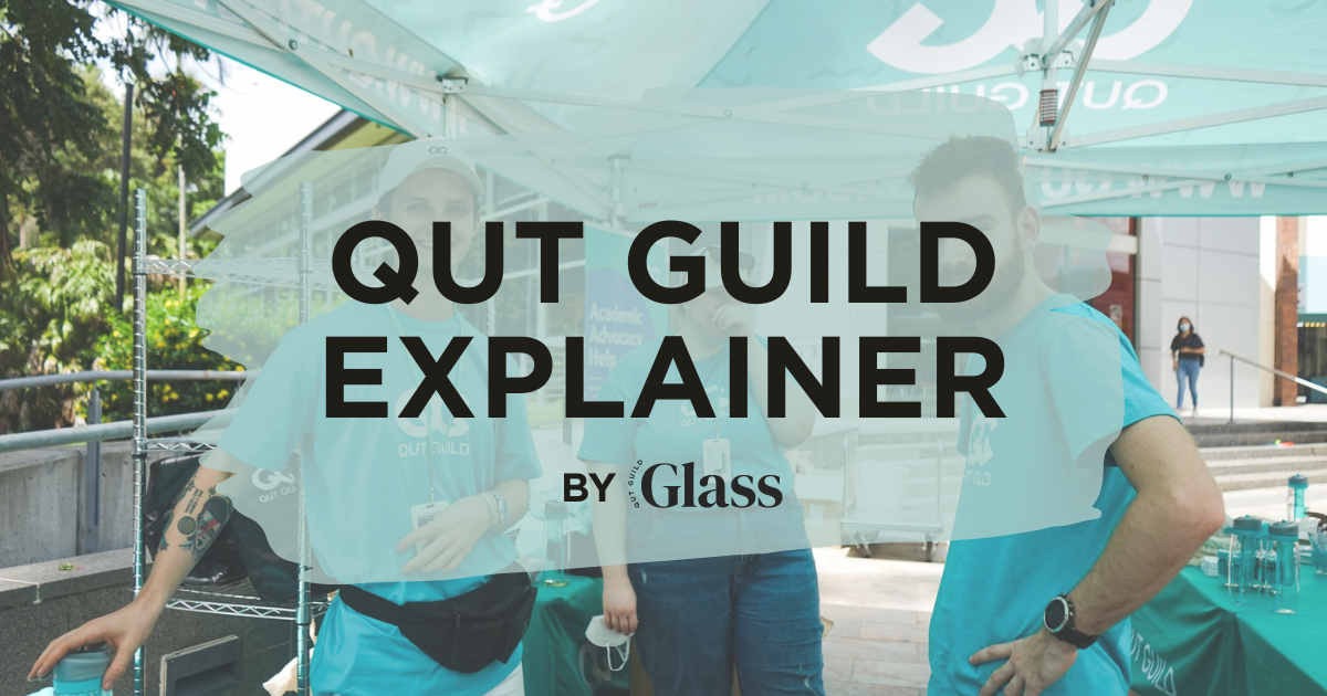 Three students standing under a teal tent, wearing the Guild Exec shirt.
